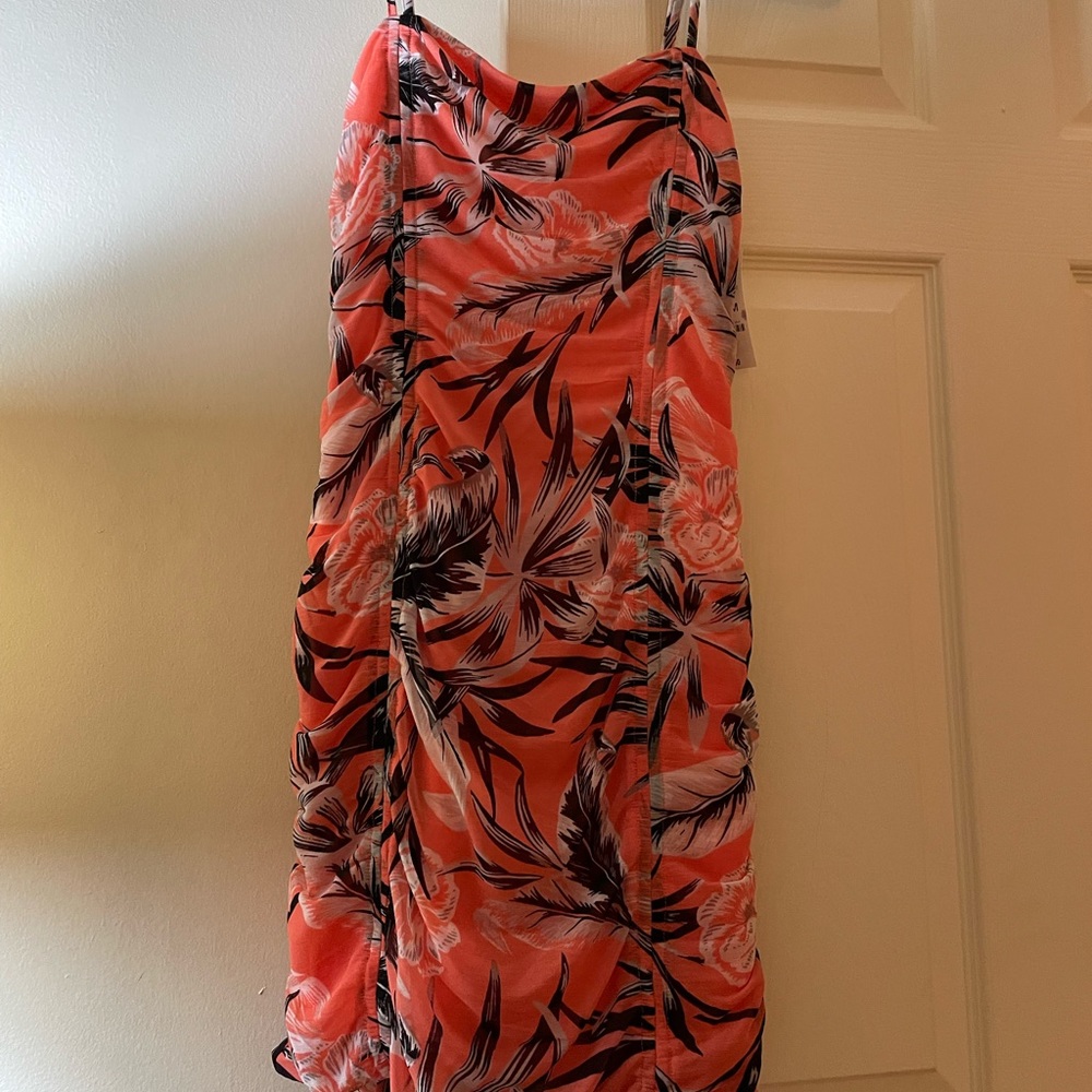 A summer dress that can be adjusted to be short or long by using front straps.